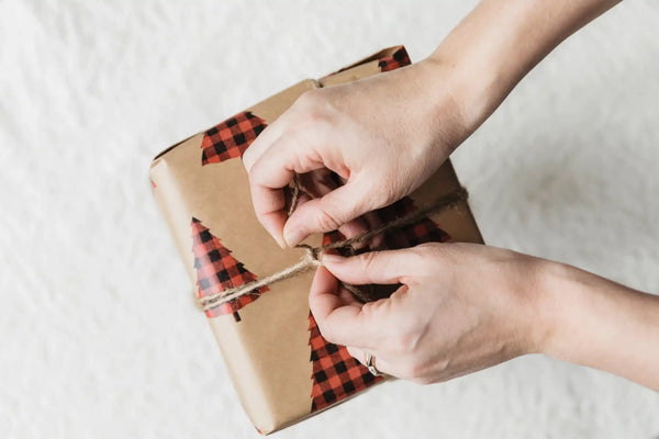 Brown kraft paper gift wrap with red plaid trees design, 12x30 inches.