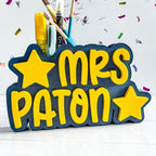 Personalized pencil holder with 'MRS PATON' text and stars on a white background
