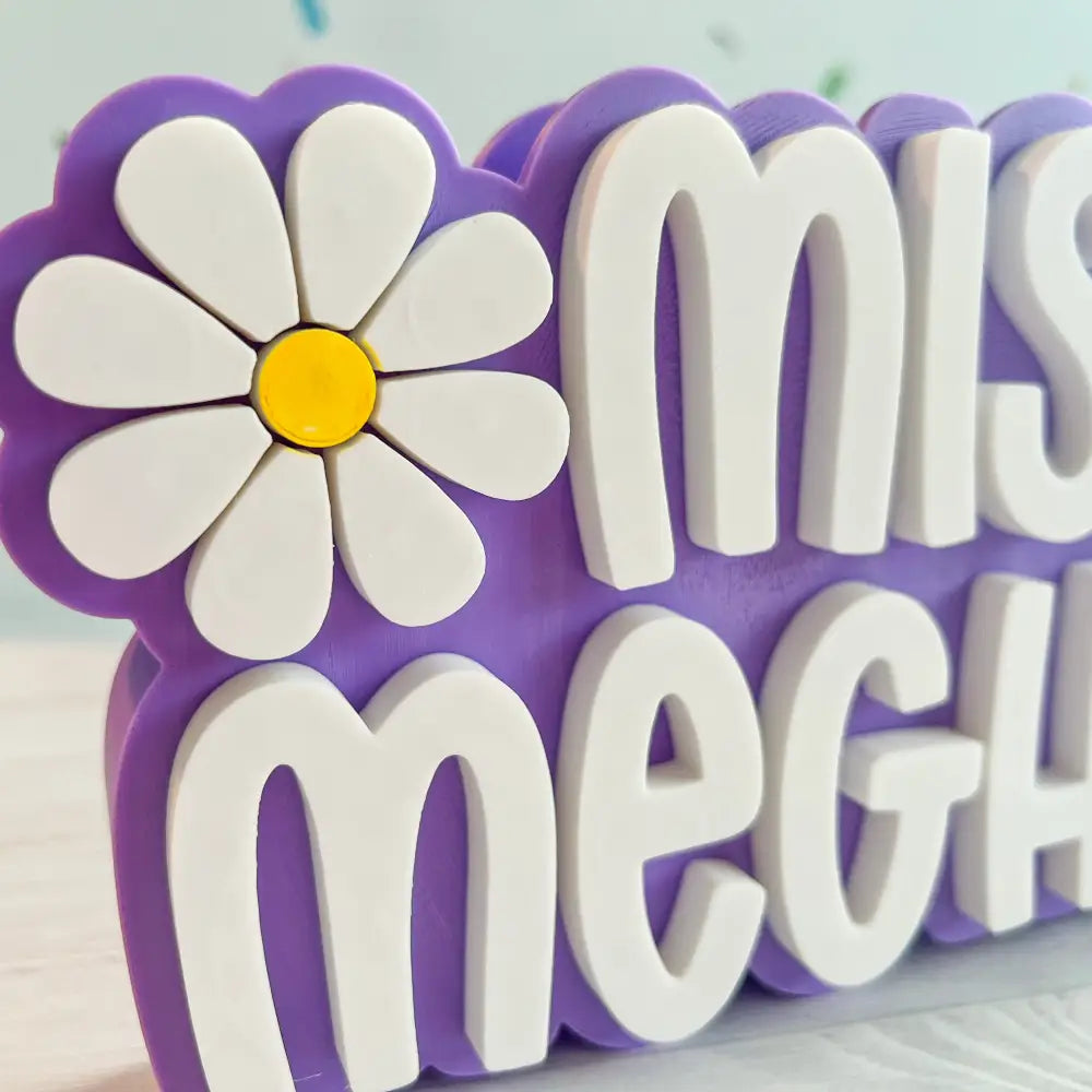 Decorative sign with a flower and text on a light background